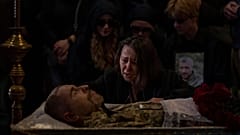 A relative cries next to the body of Viacheslav Nalyvaiko, a Ukrainian military officer killed during fighting against Russians, at his funeral in Kyiv 7 September 2022