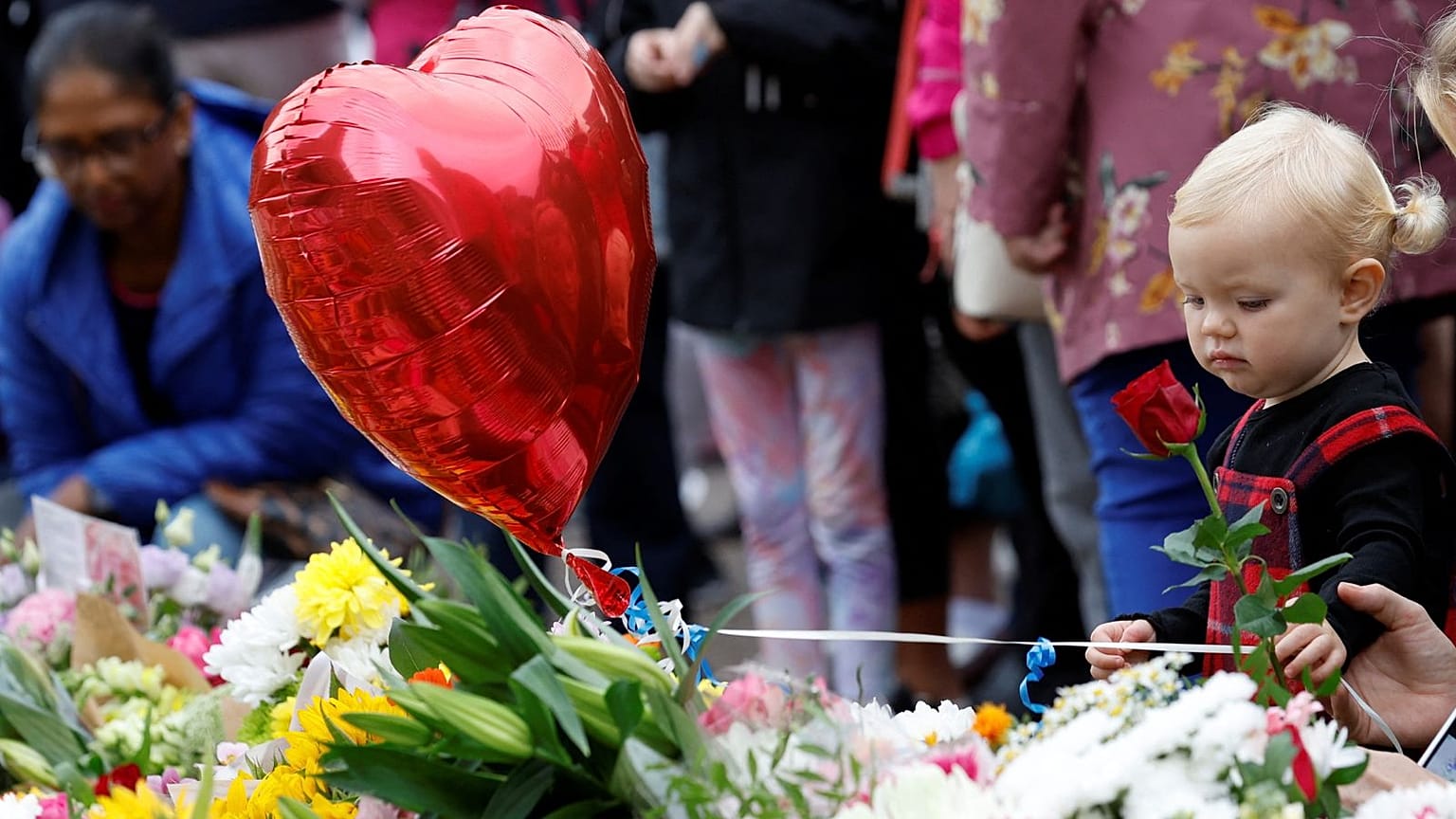 A young girl was among those leaving flowers outside Windsor Castle this morning, following the Queen's death at the age of 96.