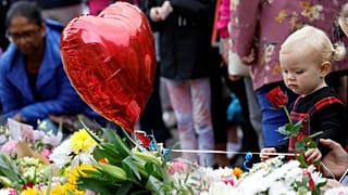 A young girl was among those leaving flowers outside Windsor Castle this morning, following the Queen's death at the age of 96.