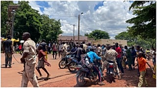 حشد يتجمع حول رجل (لم يظهر) يشتبه في مشاركته في هجوم "إرهابي" أحبط أمام القاعدة العسكرية في كاتي، مالي، 22 يوليو، 2022.