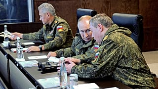 Russian President Vladimir Putin speaks to General Staff chief, Gen. Valery Gerasimov during the Vostok 2022 military exercises on 6 September 2022