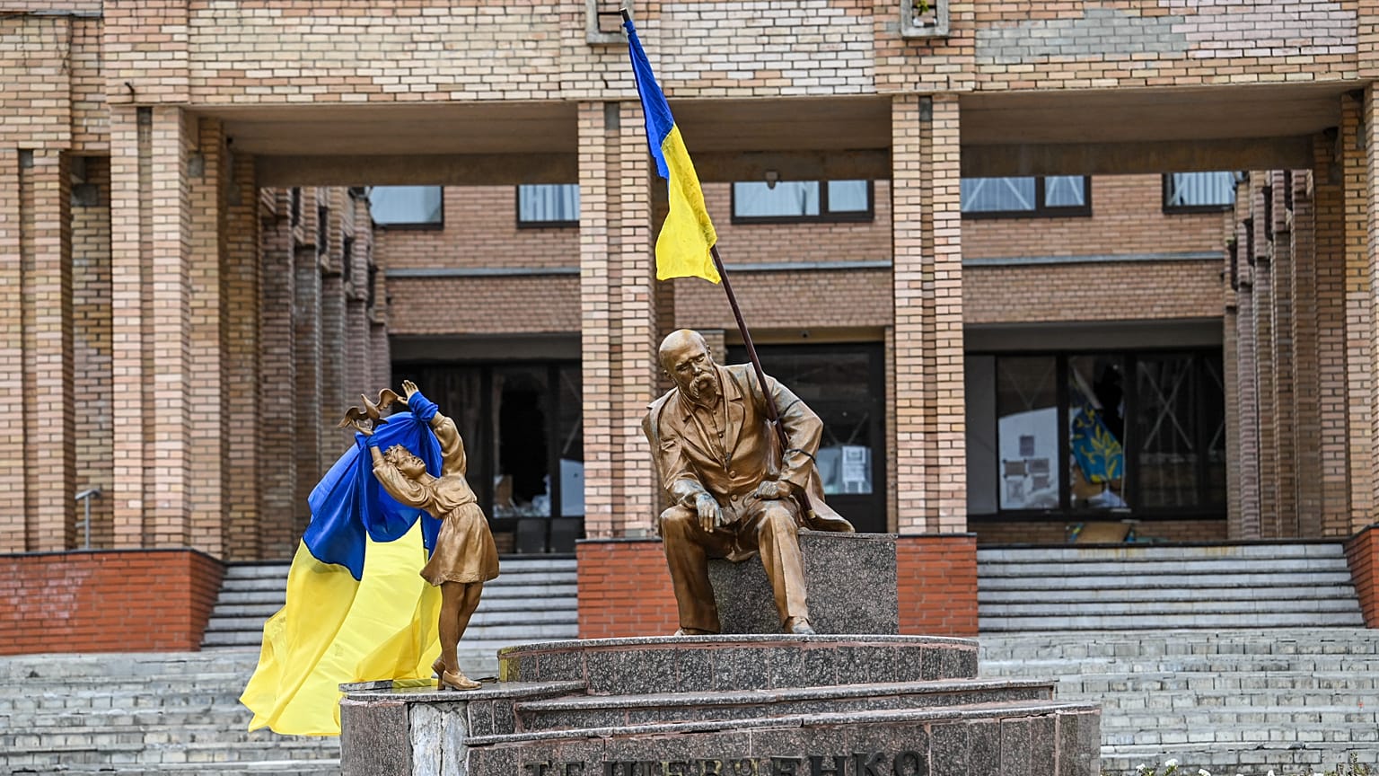 Une photo prise le 10 septembre 2022. Des drapeaux ukrainiens sont placés sur des statues sur une place de Balaklia.