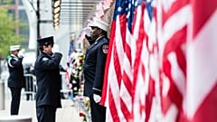 Firefighters salute each other outside the FDNY Engine 10, Ladder 10 fire station near the commemoration ceremony of the September 11, 2001 terror attacks. 