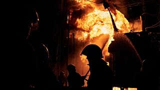 Ukrainian State Emergency Service firefighters put out a fire after a Russian rocket attack hit an electric power station in Kharkiv, Ukraine, Sunday, Sept. 11, 2022.