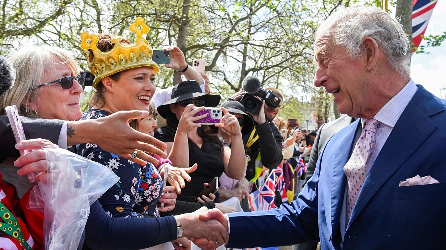 Britain's King Charles III greets well-wishers outside Buckingham Palace, in London, Friday, 5 May, a day before his coronation takes place at Westminster Abbey.