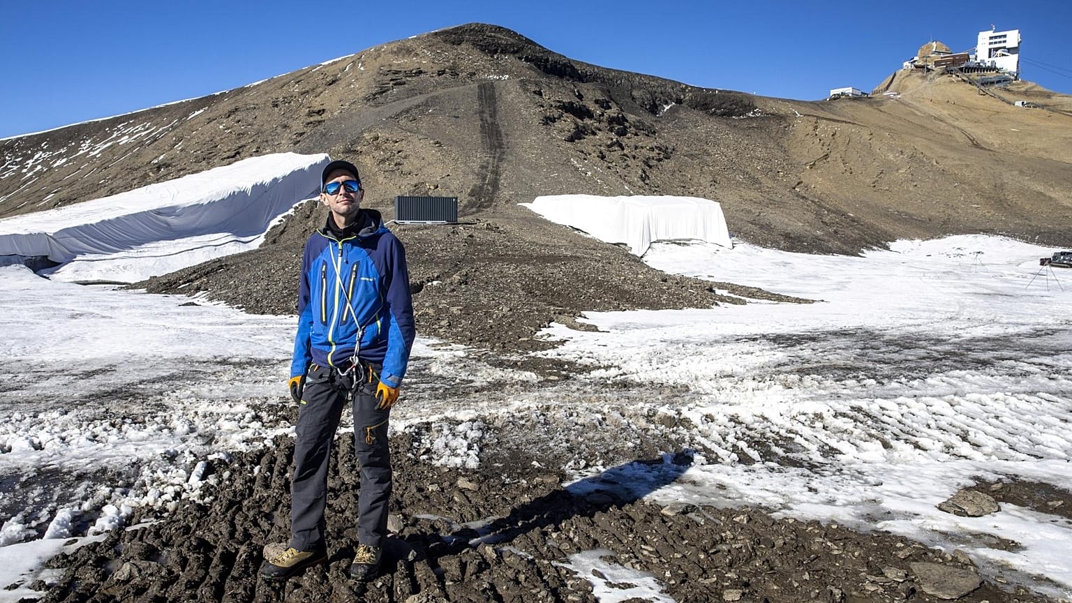 Glaciologist Mauro Fischer stands at the newly uncovered path between the Scex-Rouge and the Zanfleuron Glaciers.