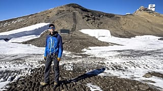 Glaciologist Mauro Fischer stands at the newly uncovered path between the Scex-Rouge and the Zanfleuron Glaciers.
