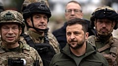 Ukrainian President Volodymyr Zelenskyy poses for a photo with soldiers after attending a national flag-raising ceremony in the freed Izium, Ukraine, Wednesday, Sept. 14, 2022