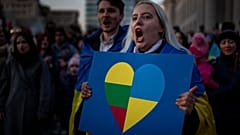 People take part in a protest against the Russian invasion of Ukraine at Independence Square at the Parliament Palace in Vilnius, Lithuania, Thursday, March 24, 2022