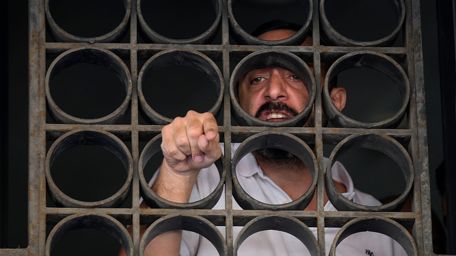 Abed Soubra, who is allegedly holding hostages in a bank in an effort to get to funds in his account, speaks with media in Beirut, Lebanon. 