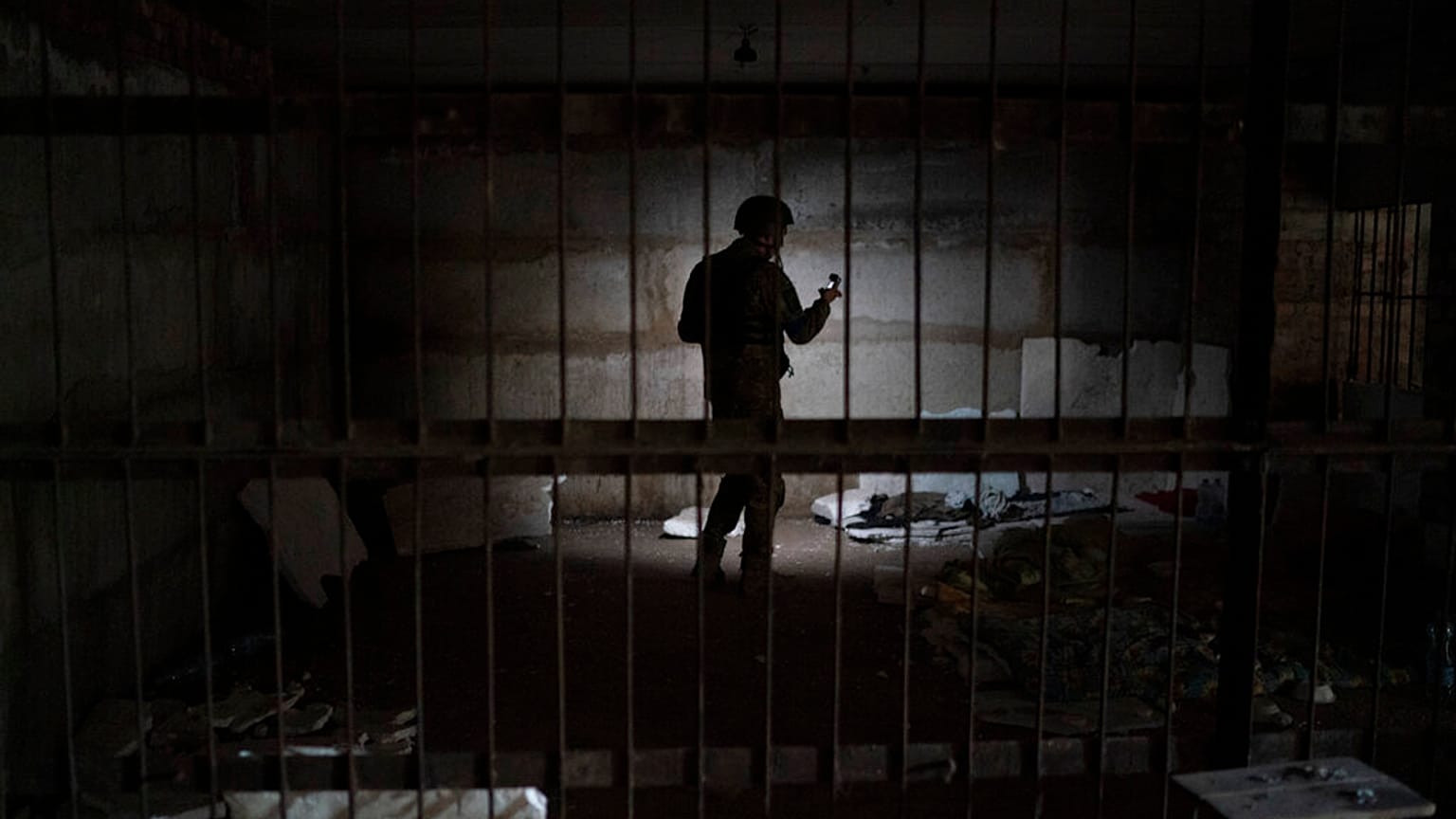 An Ukrainian serviceman stands in a basement in the retaken village of Kozacha Lopan, Ukraine, Saturday, Sept. 17, 2022.