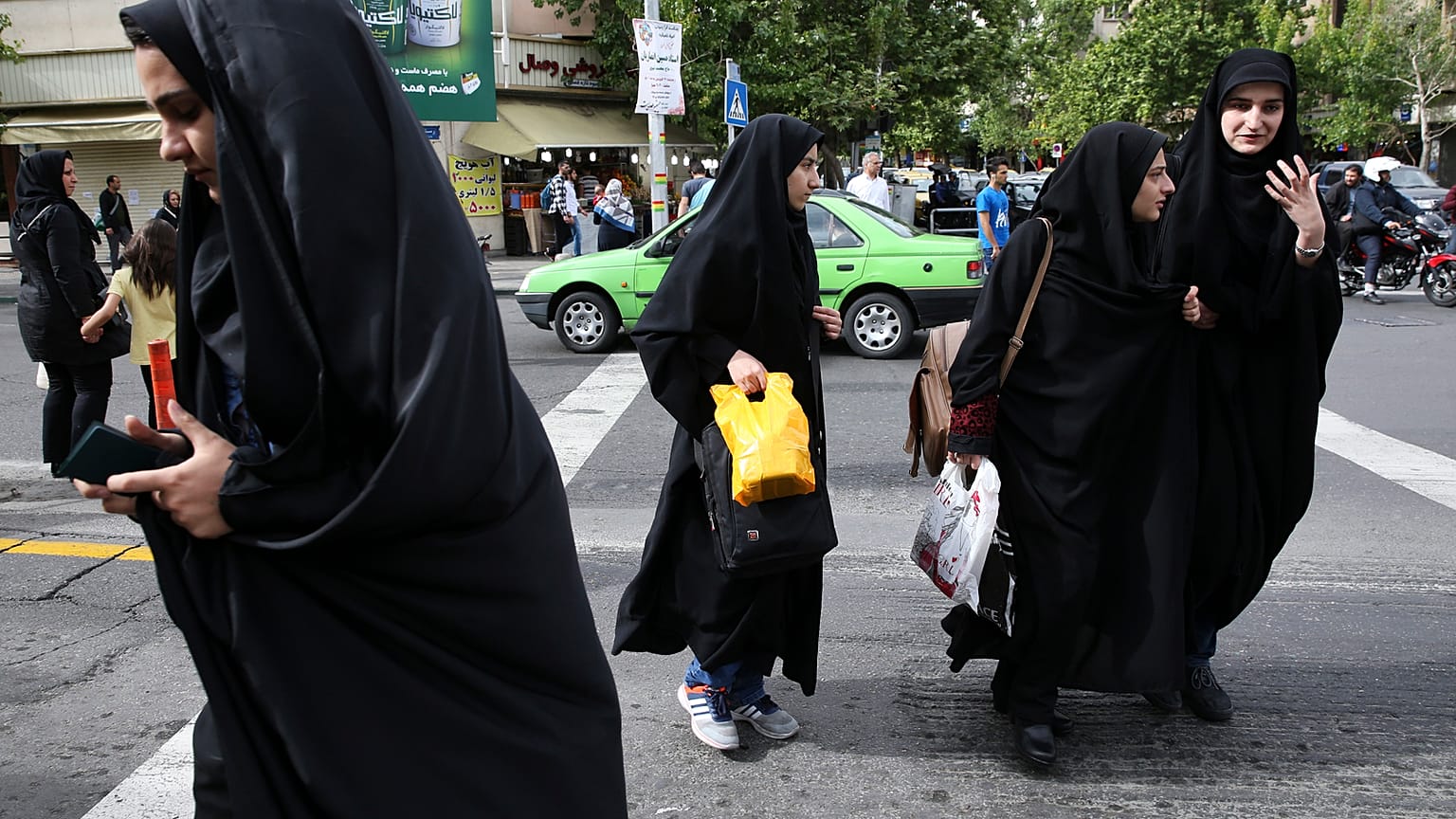Iranian women wearing headscarves crossing a street in Tehran, Iran. Sunday, 22 April 2018.