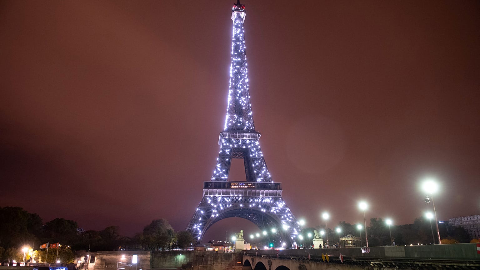 This file photograph taken on November 10, 2018, shows an illuminated Pont d'Iena leading to The Eiffel Tower in Paris.