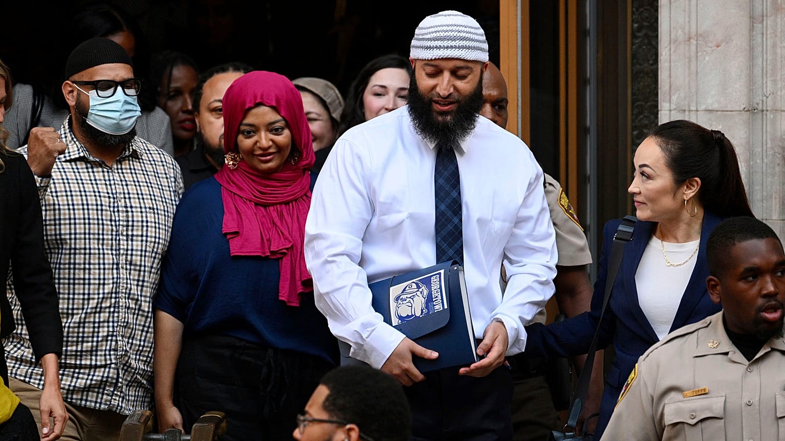 Adnan Syed, center right, leaves the courthouse after the hearing, Monday, Sept. 19, 2022
