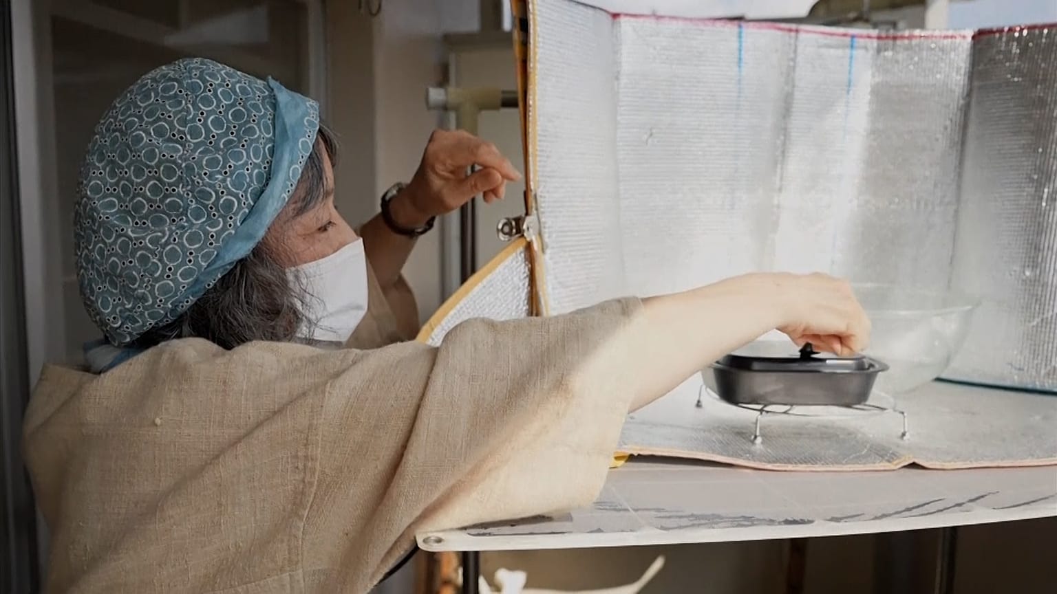 Chikako uses the sun's energy to cook her food