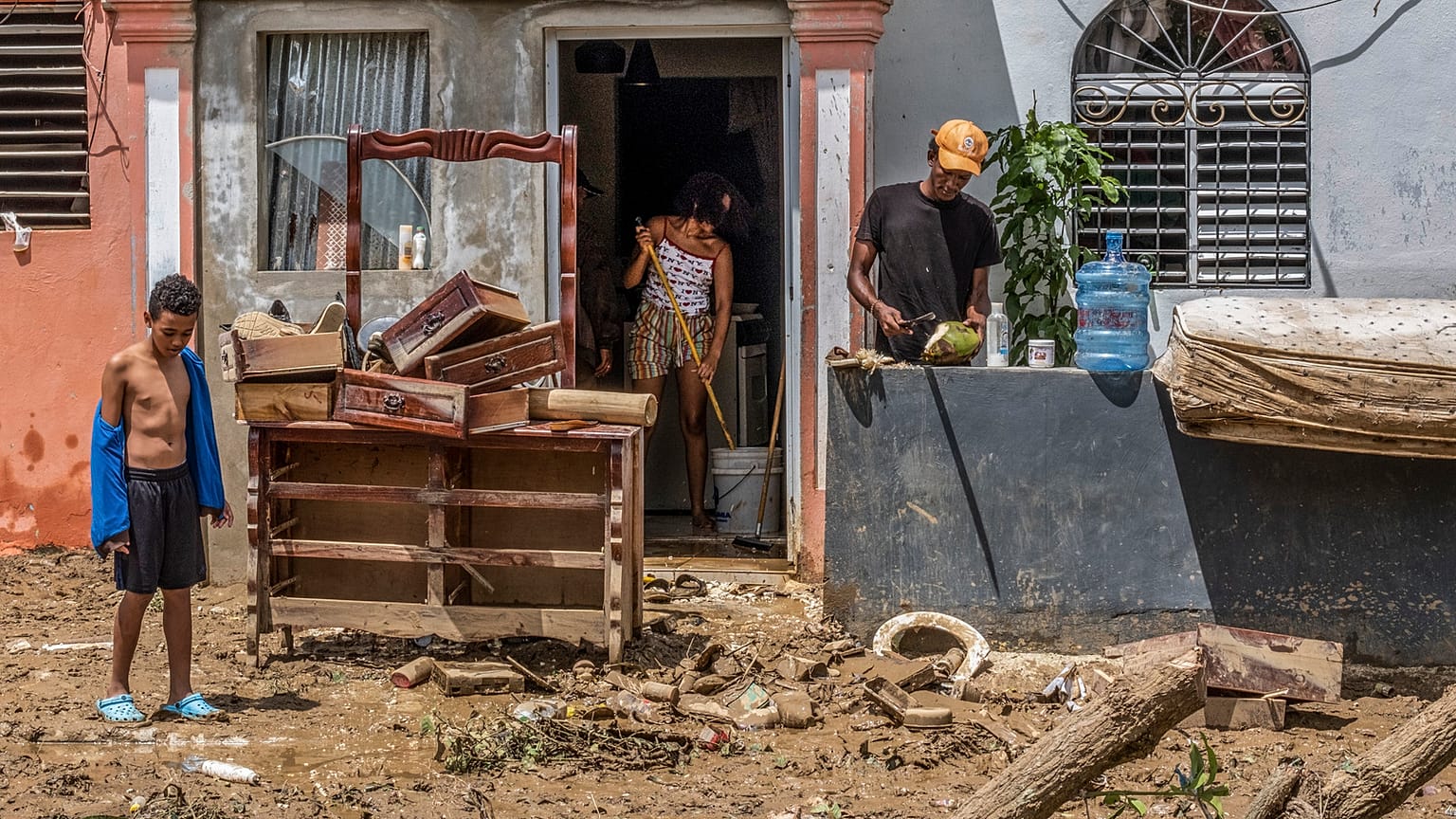 Neighbours work to recover their belongings from the flooding caused by Hurricane Fiona in Higüey, Dominican Republic, Tuesday, 20 September 2022