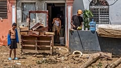 Neighbours work to recover their belongings from the flooding caused by Hurricane Fiona in Higüey, Dominican Republic, Tuesday, 20 September 2022