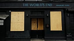 The World's End pub, which is a traditional place name for a boundary or the edge of an urban area, stands temporarily closed with boarded up windows due to Covid, 2020.  