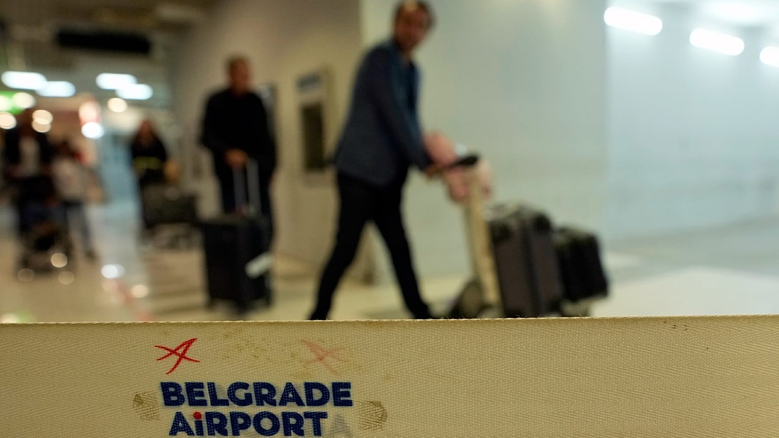 Passengers pass through the airport building in Belgrade, Serbia, Wednesday, Sept. 21, 2022.