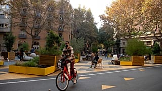 A man rides a bicycle in a pedestrian area as part of an expansion of the "superilla" (superblock) plan promoting cycling and car-free zones in Barcelona on November 14, 2020.
