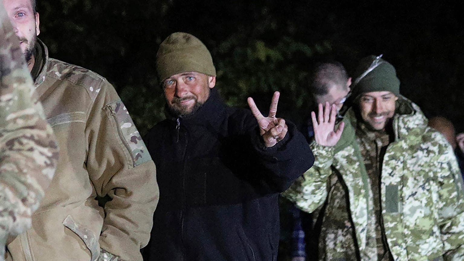 Ukrainian soldiers, who were released in a prisoner exchange between Russia and Ukraine, smile close to Chernihiv, 21 September 2022