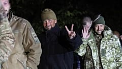 Ukrainian soldiers, who were released in a prisoner exchange between Russia and Ukraine, smile close to Chernihiv, 21 September 2022