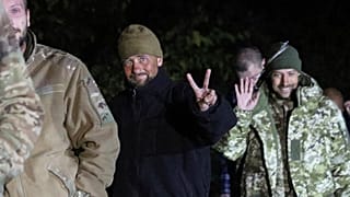 Ukrainian soldiers, who were released in a prisoner exchange between Russia and Ukraine, smile close to Chernihiv, 21 September 2022