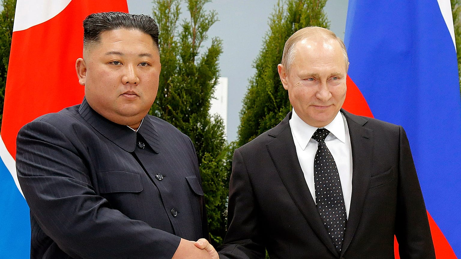 Russian President Vladimir Putin and North Korea's leader Kim Jong Un shake hands during their meeting in Vladivostok in 2019