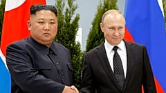 Russian President Vladimir Putin and North Korea's leader Kim Jong Un shake hands during their meeting in Vladivostok in 2019