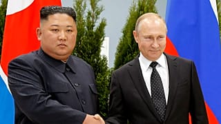 Russian President Vladimir Putin and North Korea's leader Kim Jong Un shake hands during their meeting in Vladivostok in 2019