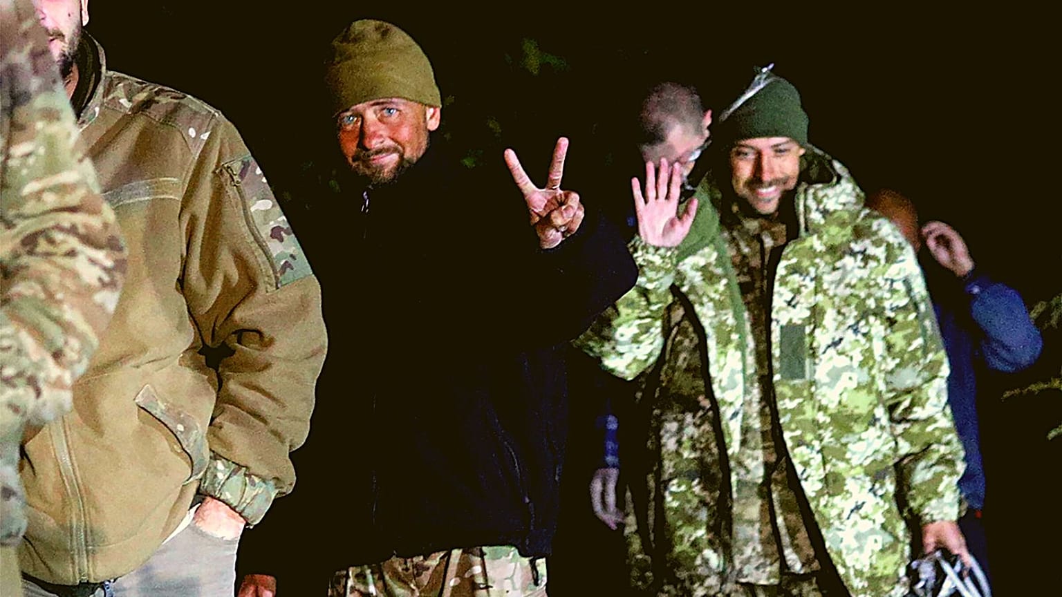 Ukrainian soldiers, who were released in a prisoner exchange between Russia and Ukraine, smile close to Chernihiv, Ukraine, late Wednesday, Sept. 21, 2022. 