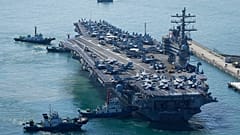 The U.S. carrier USS Ronald Reagan is escorted as it arrives in Busan, South Korea, Friday, Sept. 23, 2022.