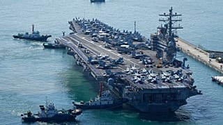 The U.S. carrier USS Ronald Reagan is escorted as it arrives in Busan, South Korea, Friday, Sept. 23, 2022.