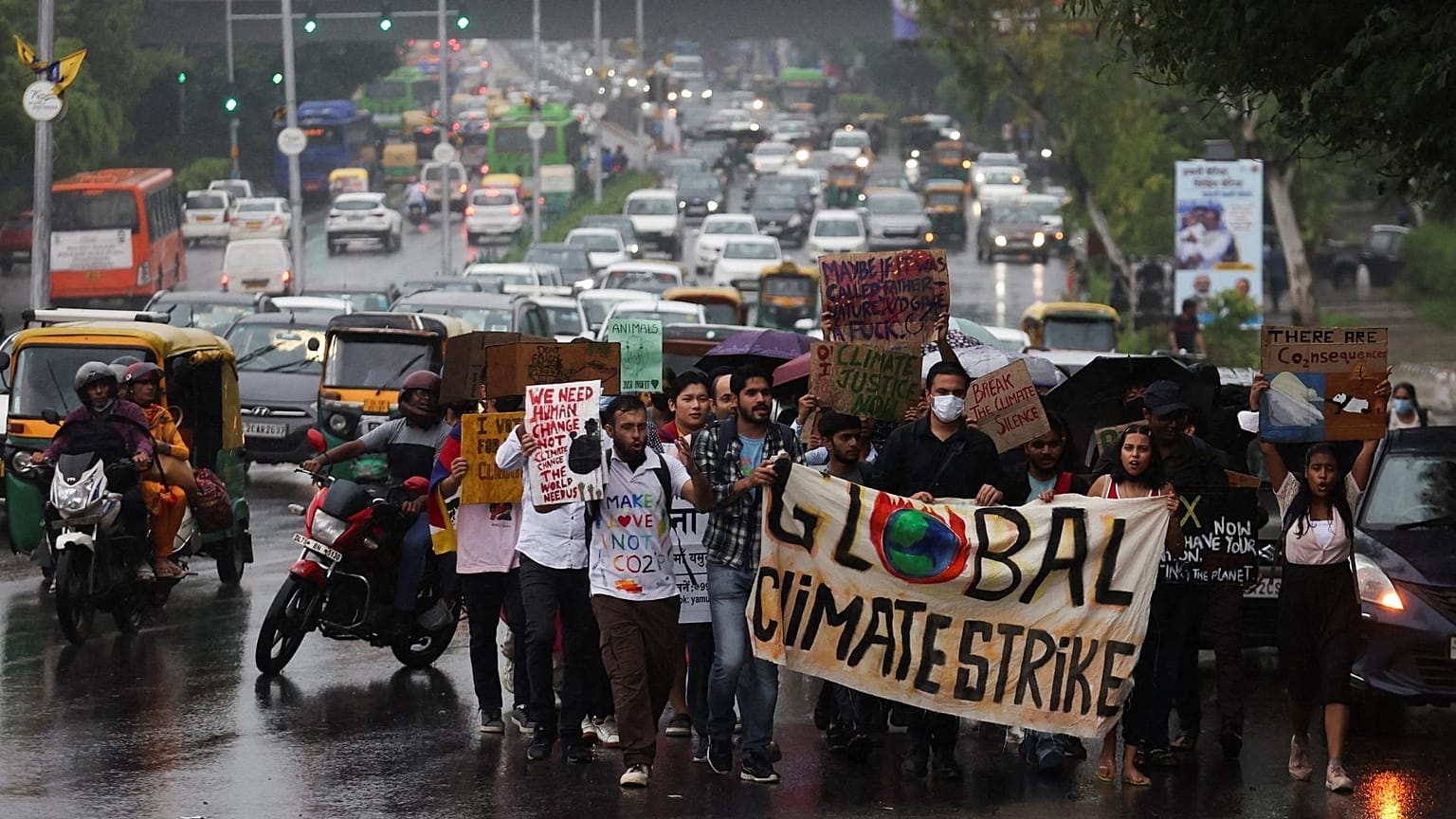 People take part in a "Global Climate Strike" march towards the Delhi Secretariat building, calling for urgent measures to combat climate change.