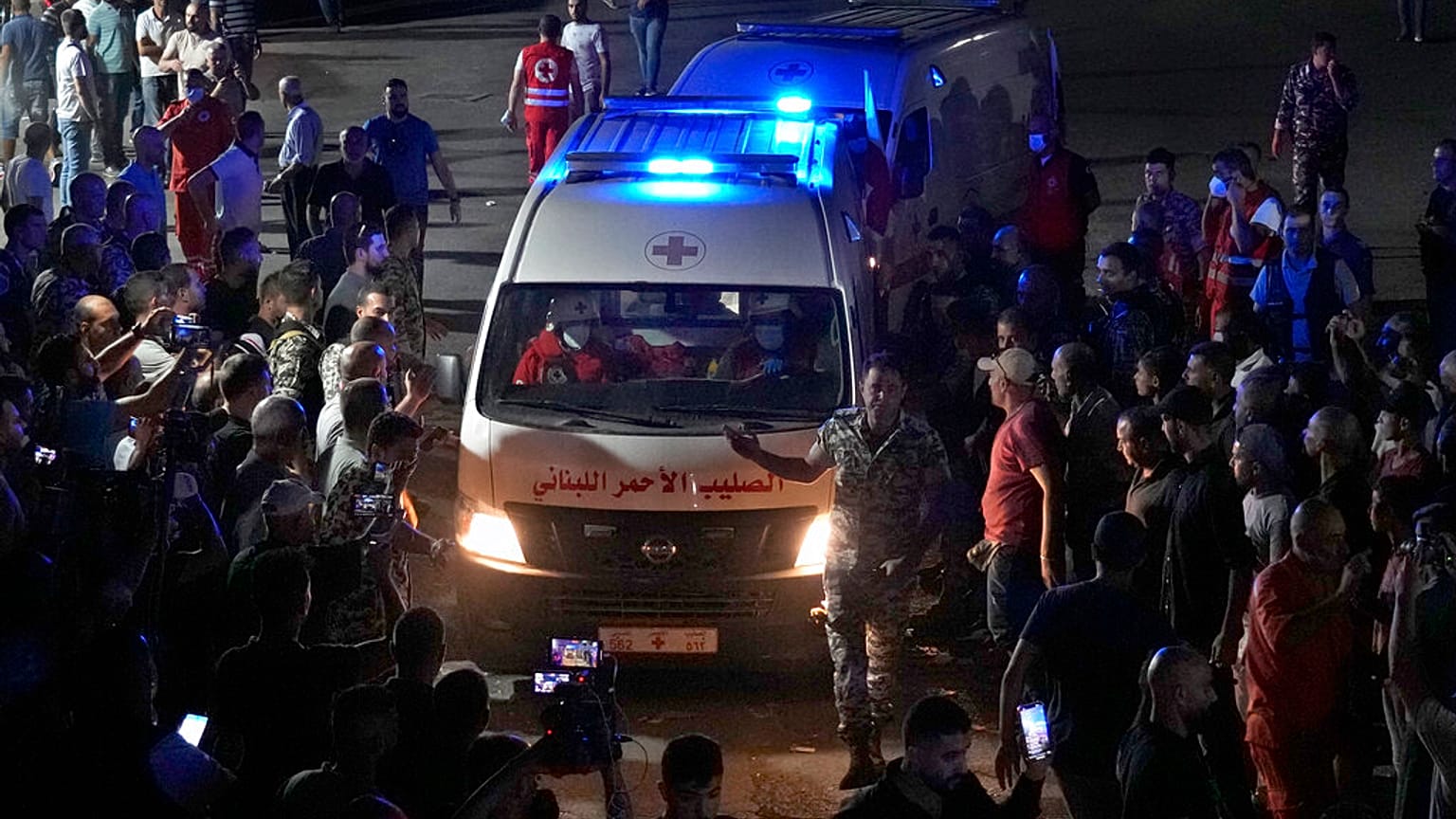 Red Cross ambulances carrying bodies of those died on a boat carrying migrants from Lebanon that sank in Syrian waters