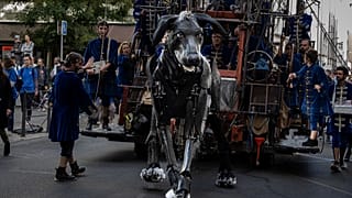 Schauspielerin spielt mit Xolo, der 300 kg schweren Hundemarionette des Straßentheaterensembles Royal de Luxe in Villeurbanne