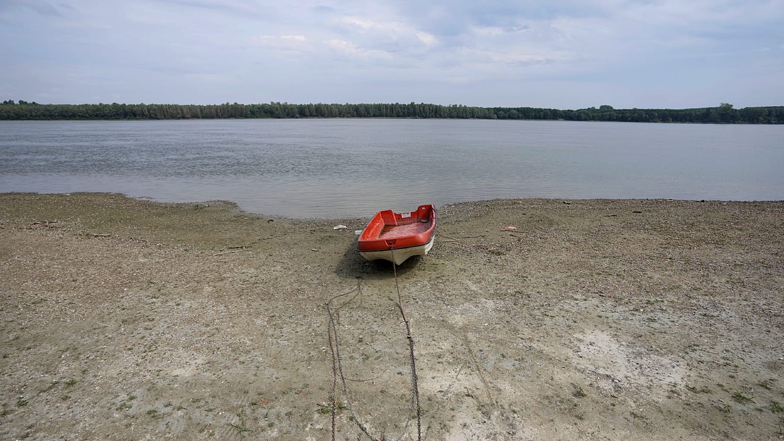 A boat laying on a dry bank of river Danube after a long time of drought near the village of Cortanovci, 50 kms north-west of Belgrade, Serbia, Aug. 9, 2022.