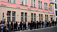 FILE --People from Ukraine, most of them refugees fleeing the war, wait in front of the consular department of the Ukrainian embassy in Berlin, Germany, on April 1, 2022.