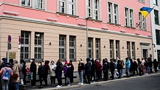 FILE --People from Ukraine, most of them refugees fleeing the war, wait in front of the consular department of the Ukrainian embassy in Berlin, Germany, on April 1, 2022.