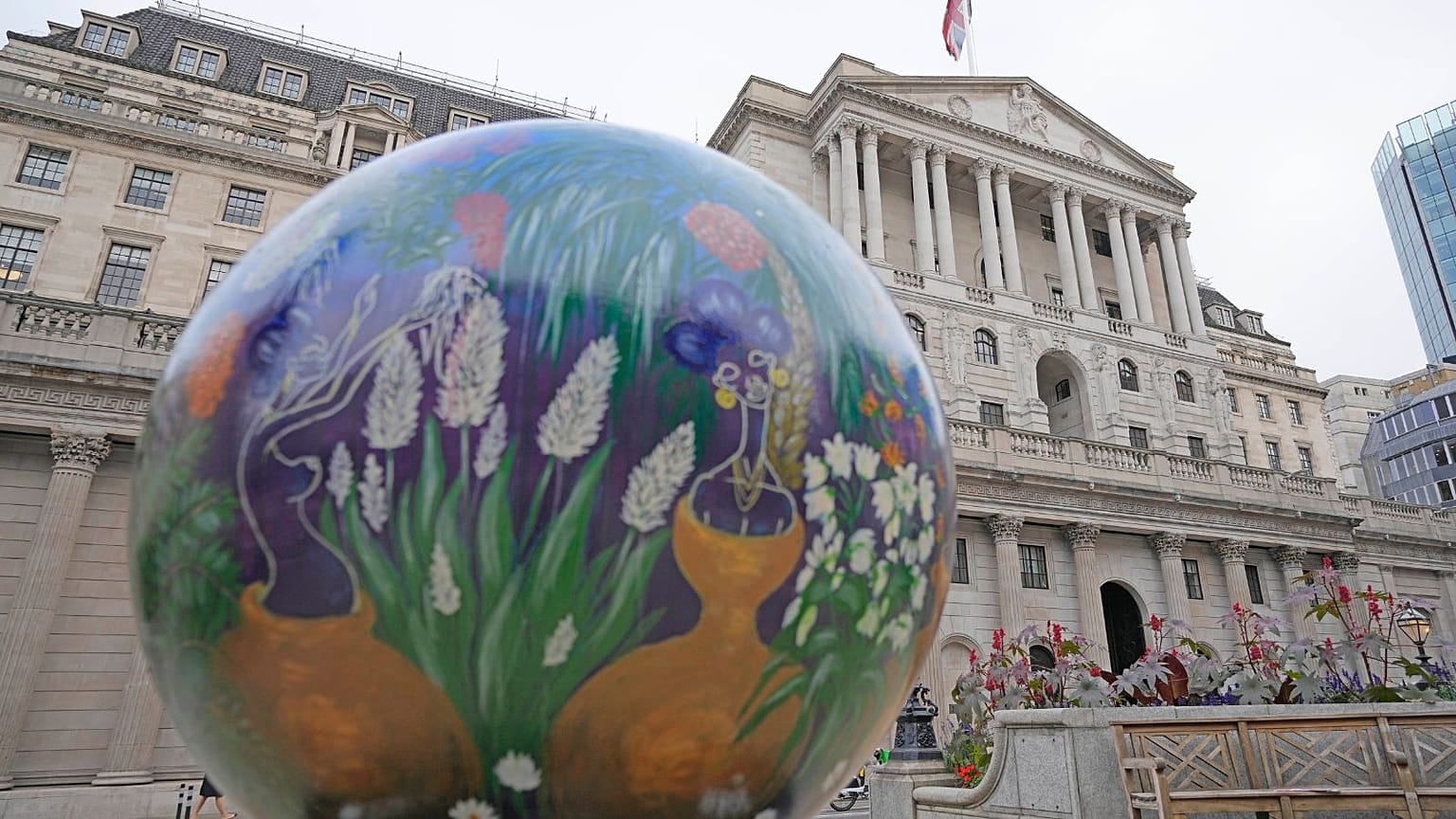 A globe sits beside the Bank of England in London, Tuesday, Sept. 27, 2022