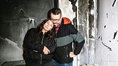 Anastasia and Roman Akulenko stand in their flat covered with ash. Irpin, Kyiv suburb, Ukraine. September 27, 2022