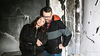 Anastasia and Roman Akulenko stand in their flat covered with ash. Irpin, Kyiv suburb, Ukraine. September 27, 2022