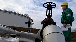 An engineer of the Hungarian Oil and Gas Company checks the receiving area of the Druzhba oil pipeline in the country's largest oil refinery in Szazhalombata, Jan. 9, 2007. 