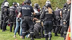 Police scuffle with demonstrators outside Iran's embassy in Oslo.