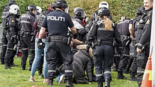 Police scuffle with demonstrators outside Iran's embassy in Oslo.