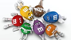 The M&Ms team with their new character, Purple