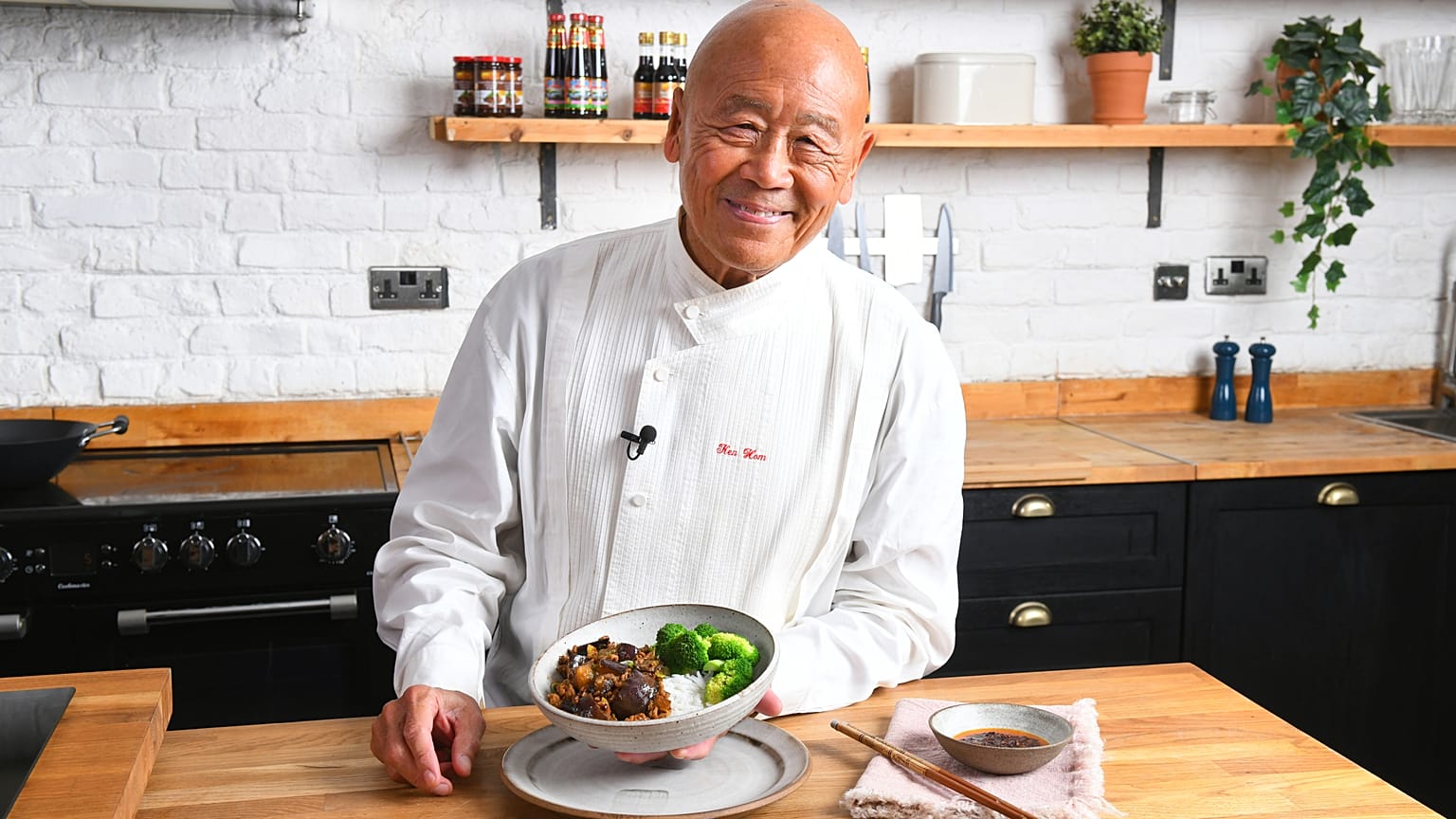 Ken Hom posing with a dish