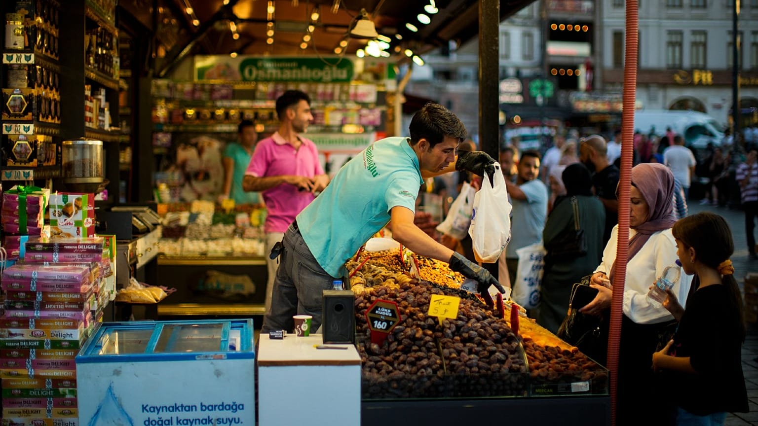 A clerk talks to a customer at the Egyptian spices market in Istanbul, Turkey, Thursday, Aug. 18, 2022. 