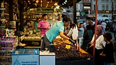 A clerk talks to a customer at the Egyptian spices market in Istanbul, Turkey, Thursday, Aug. 18, 2022. 