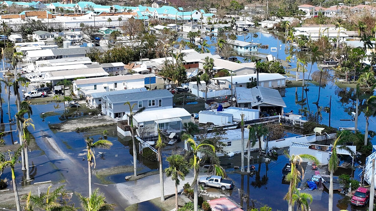 Water floods a damaged trailer park in Fort Myers